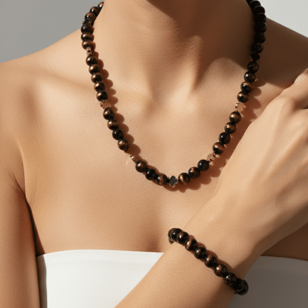 Necklace and bracelet with brown beads on a person against a neutral background